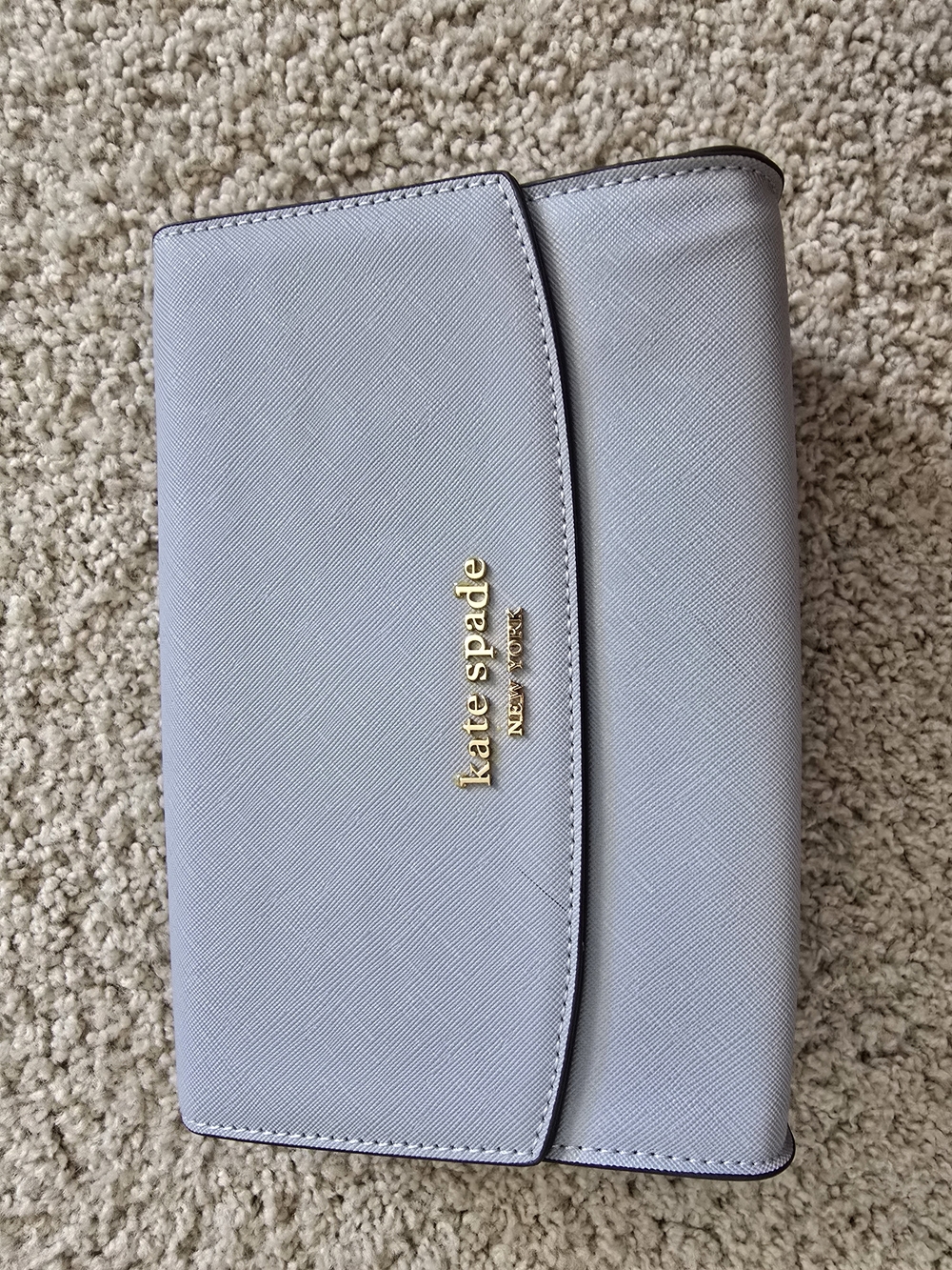 kate spade light blue Saffiano wristlet clutch with gold logo